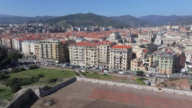 Historic Priamar Fortress overlooks sunny Savona cityscape and distant mountains