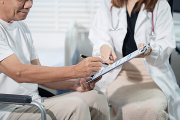man patient filling insurance legal document at appointment with doctor. Elderly patient signing...