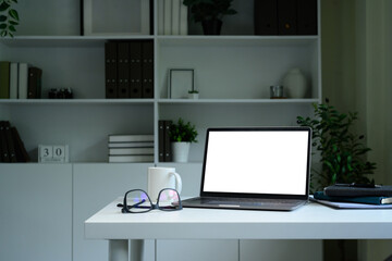 Laptop computer blank screen with clipping path on table. Workspace concept.