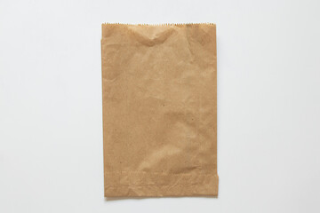 Brown paper bag on white background as mockup, kraft paper packaging, top view