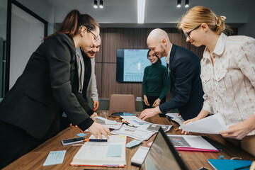 Fototapeta premium Employees dynamically interacting and discussing work in a modern office. A true representation of teamwork, creativity, and professional collaboration.