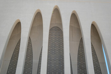 the facade of a building with arches and columns
