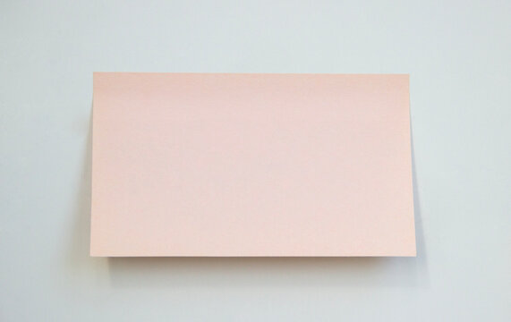 blank pink rectangular sticky note isolated on neutral background