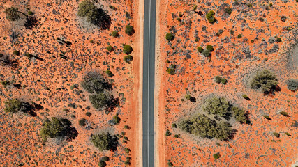 Aerial of straight road through the red outback