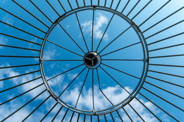 Metal framework gazes at the vibrant sky, revealing an intricate web of structure and light during...