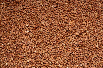 Dry uncooked brown buckwheat groats. Russian, Ukrainian and Belarusian Culture. Background - top view, flat lay.