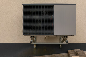 Modern outdoor cooling unit attached to a building showcasing sleek design and efficient technology...