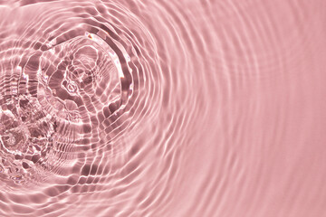 Pink water ripple texture background on the harsh light.	