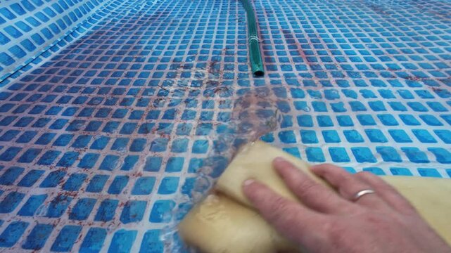 cleaning the pool from dirt and preparing for the bathing season