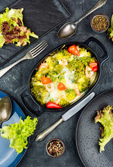 Oven baked broccoli topped with melted mozzarella and prawns.