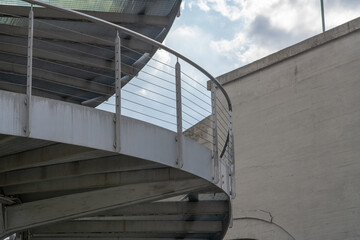 helical pedestrian ramp project in external steel, modern and innovative design staircase, for contemporary architecture. stainless steel design is designed for a pedestrian overpass in a public area.