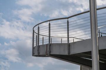 helical pedestrian ramp project in external steel, modern and innovative design staircase, for contemporary architecture. stainless steel design is designed for a pedestrian overpass in a public area.