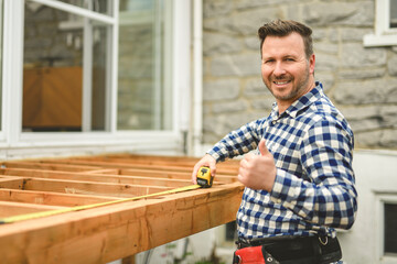 Handyman worker making patio outside close to a pool