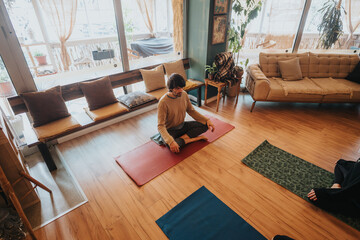 A serene indoor scene featuring an individual practicing yoga meditation on a mat, surrounded by...