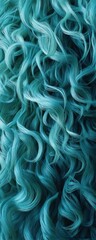 A vibrant, textured display of flowing aqua-colored strands, resembling waves or curls, showcasing a dynamic and artistic pattern.