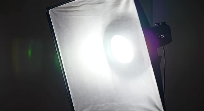 Professional photography lighting setup with softbox and camera equipment in studio environment