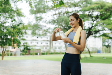Athlete hydrating during outdoor workout urban park photography natural light side view fitness...