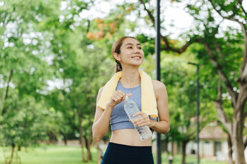 Athlete hydrating during outdoor workout urban park photography natural light side view fitness...