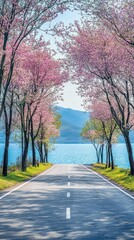 Fototapeta premium Pink blossom-lined road to lake