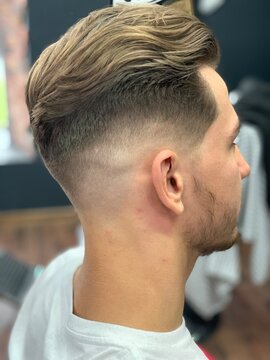 male haircut fade pompadour Male model profile showing modern low fade hair cut styled in professional barbershop