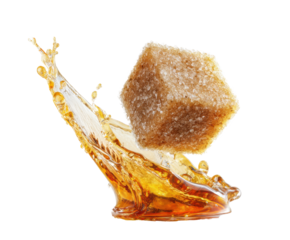 Brown sugar cube splashing in caramel syrup on a clean surface, cut out transparent