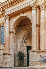 Elegant Baroque Side Entrance of Ciutadella de Menorca Cathedral. Historic Spanish architecture, classical columns, religious building, Mediterranean island, travel landmark