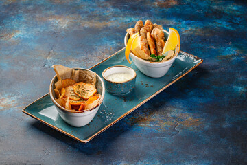 Several dishes of chicken, fish, potatoes, various salads and sauces.