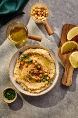Delicious hummus with olive oil, chickpeas and parsley. Top view.