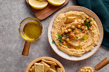 Delicious hummus with olive oil, chickpeas and parsley. Top view.