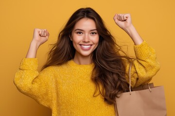 Happy woman in yellow sweater celebrates successful shopping joyful expression yellow background