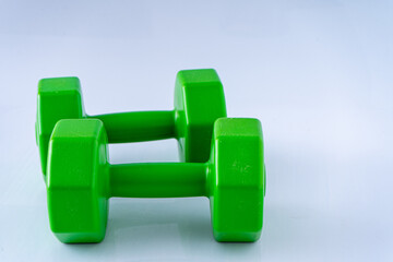 Two dumbbells 2 kg each. Sports equipment. White background. Green set. Gym