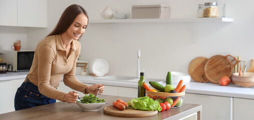 Young woman making vegetable salad in kitchen. Keto diet concept