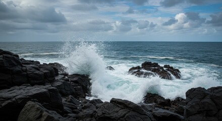 Obraz premium Dramatic long exposure of powerful ocean waves crashing against rugged rocky shorelines under a cloudy sky