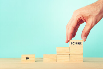 The word impossible is divided into two parts. success and challenge concept.