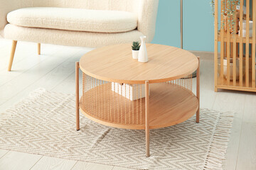 Wooden coffee table with houseplant and decor in living room
