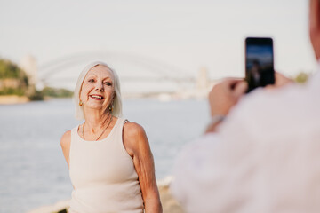 man taking a photo of his wife at Sydney Harbour