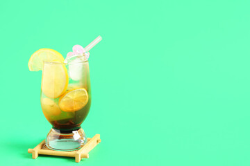 Glass of delicious Long Island iced tea on color background