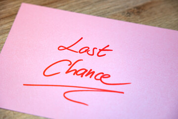Last Chance. Rose note with handwritten text in red. Opportunity, urgency, chance, event,...