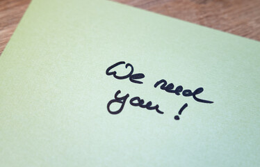 We need you! Green note with handwritten text. Opportunity, hiring, applying, searching, job search, recruitment.