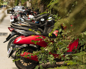 A red motorcycle is parked in a parking lot