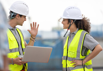 Port Engineers Discussing Logistics at a Shipping Yard, Young Industrial Workers Overseeing...