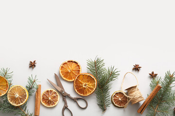 Dried orange slices with fir branches, cinnamon and star anise on grey background