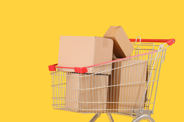 Shopping cart full of cardboard boxes on yellow background