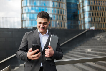 Gazing at the Bright Screen, a Young Professional Connects in the Heart of Downtown's Bustle,...