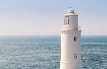 Trevose Head white Lighthouse against blue sea and clear sky in Summer, isolated close-up, Padstow, Cornwall, England, United Kingdom, UK
