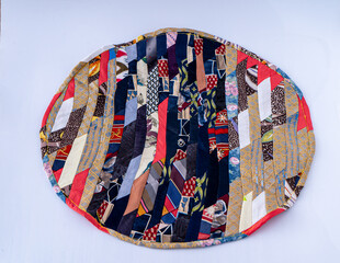 Patchwork. A fragment of multi-colored pieces of fabric sewn together. Round colorful rug.