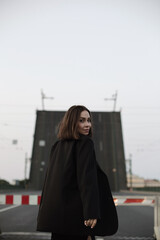 Fototapeta premium young woman walking in the street. Drawbrige