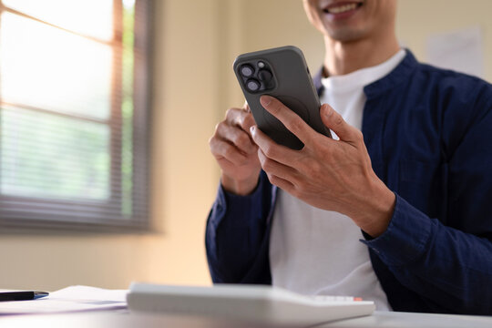 A man's hand is using a telephone to communicate.