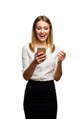 A businesswoman looking at her phone and smiling in excitement, isolated 