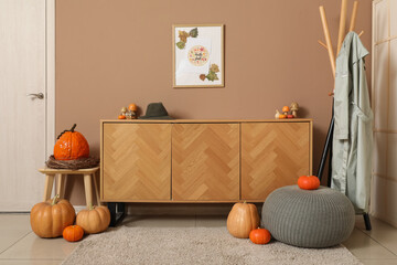 Interior of hallway with autumn decor, commode and coat rack
